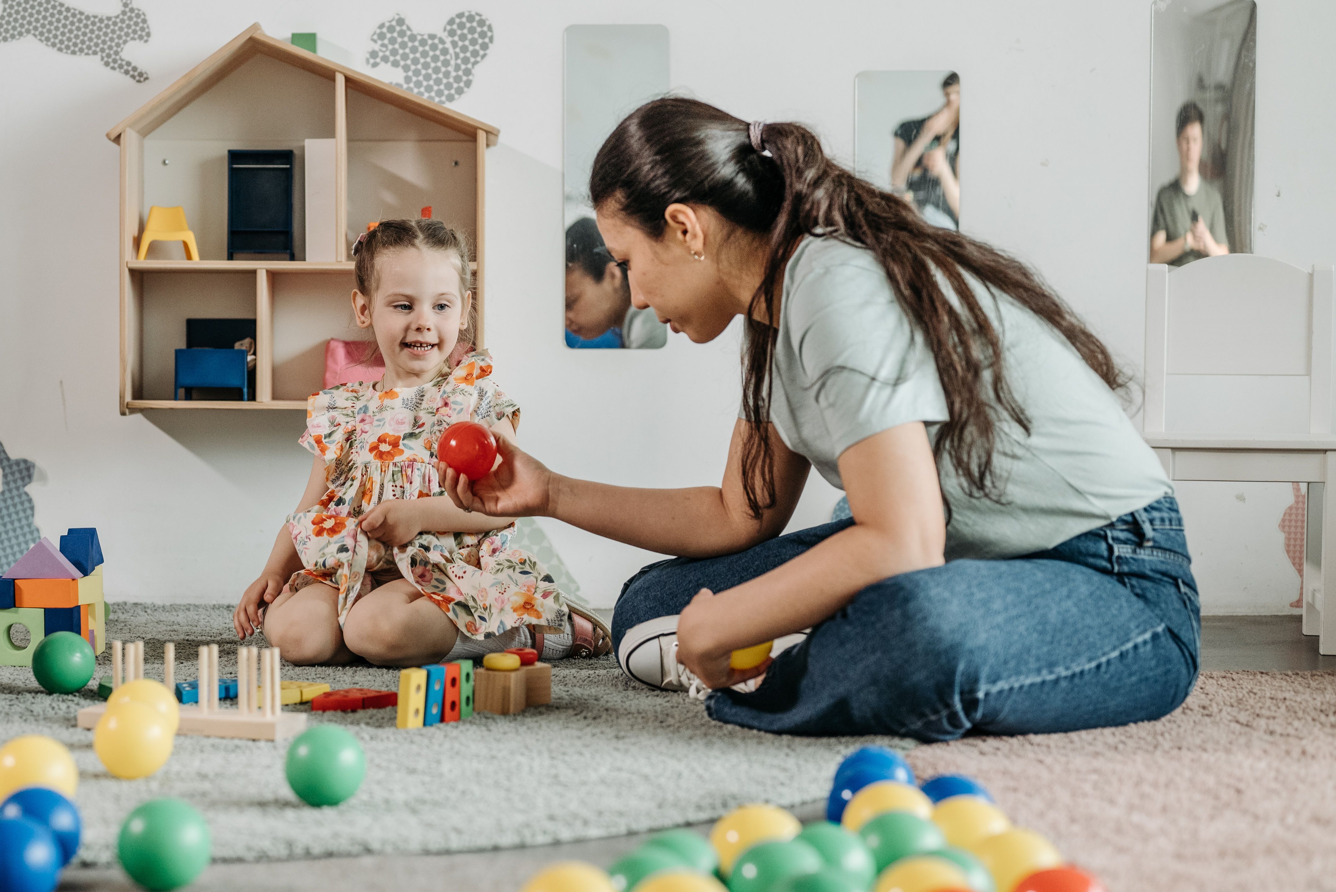 A registered behavior technician and a young child playing together during an ABA therapy session